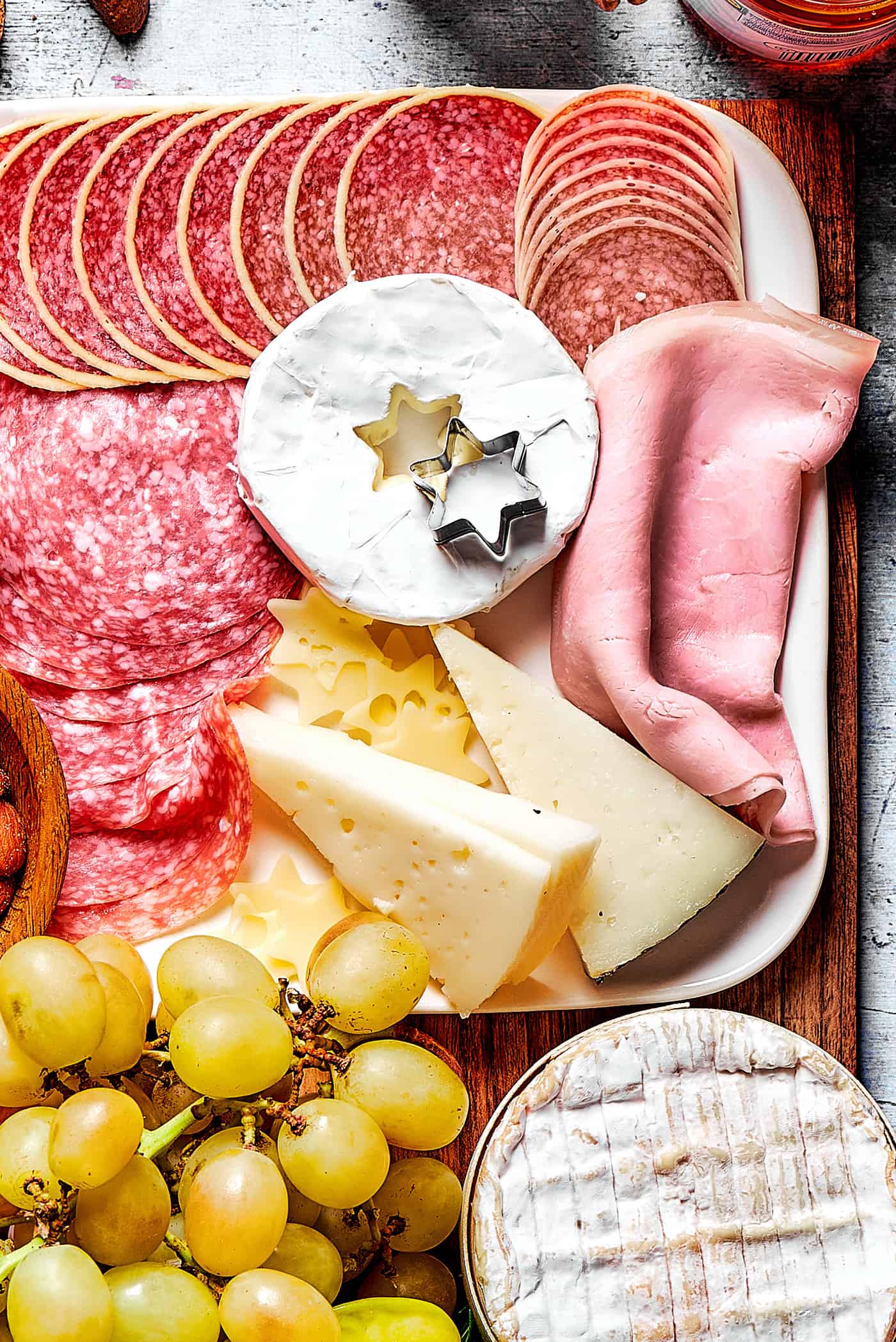 meats and cheeses on a charcuterie board for Christmas