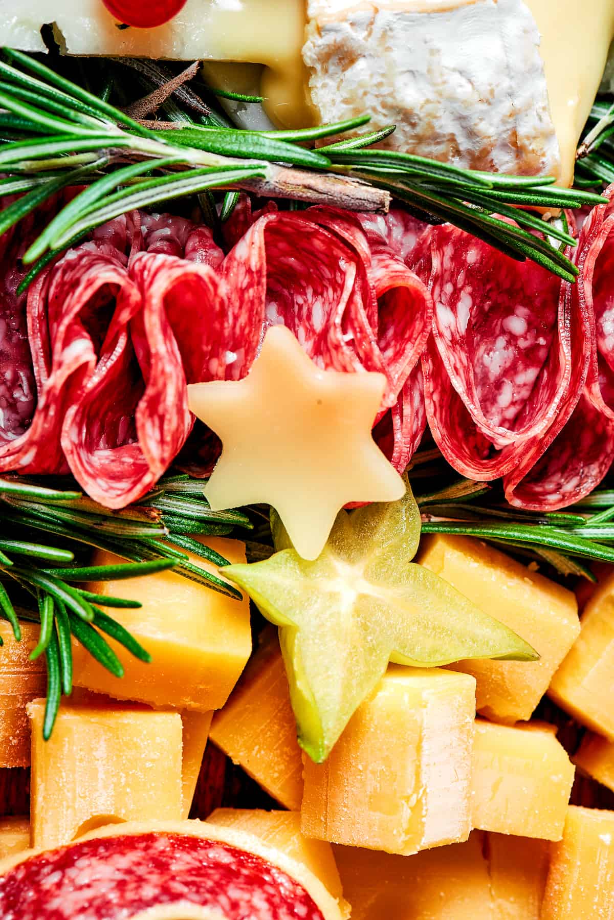 Close up of a Christmas charcuterie board with salami, cheese, and more