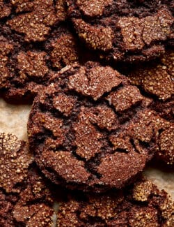 espresso cookies piled on a baking sheet