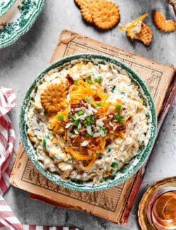 overhead photo of a creamy, cheesy dip in a serving bowl