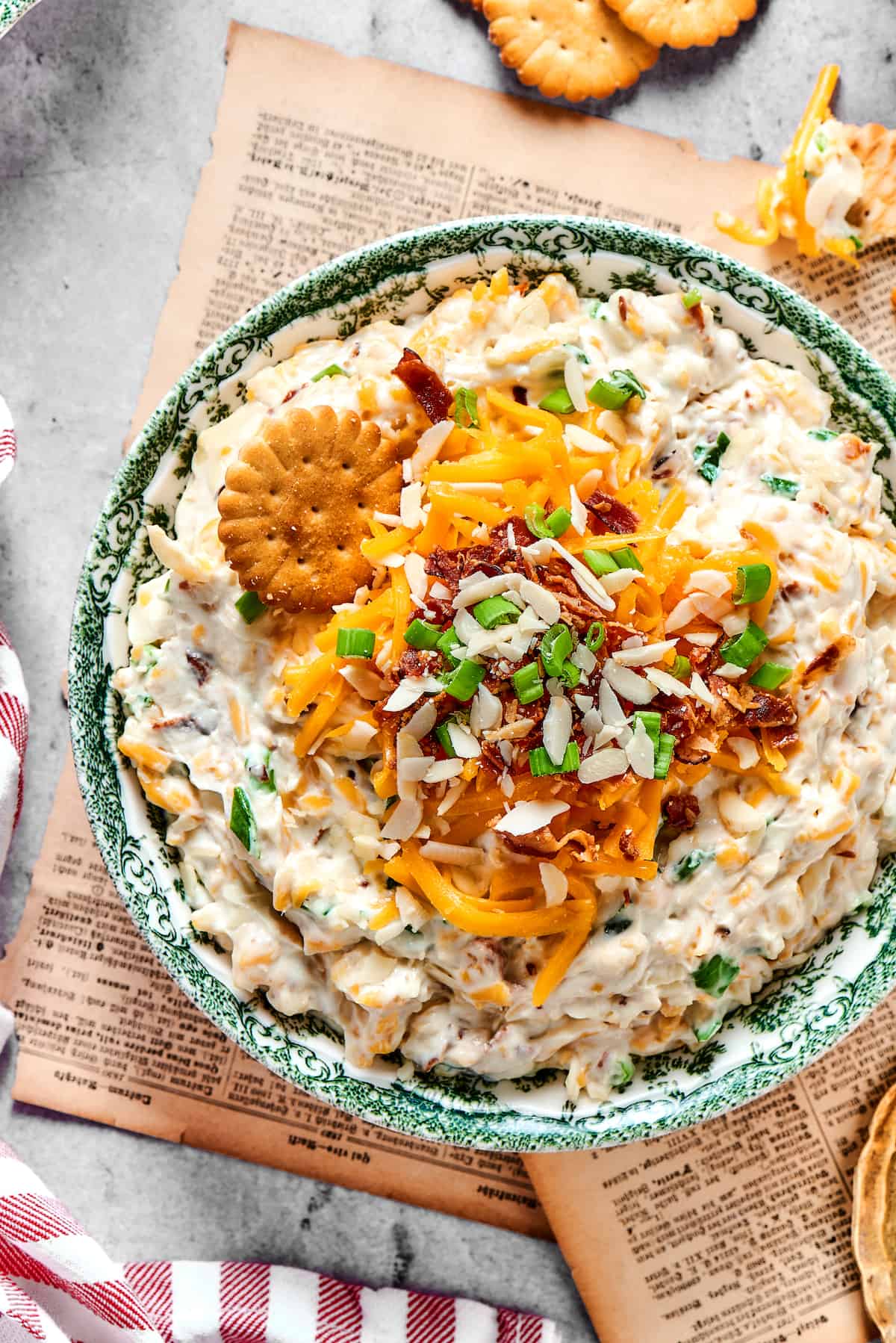 Million Dollar Dip is creamy, cheesy, and super easy to make. With cheese, bacon, and almonds, it's a super addicting party dip. Million dollar dip in a blue bowl