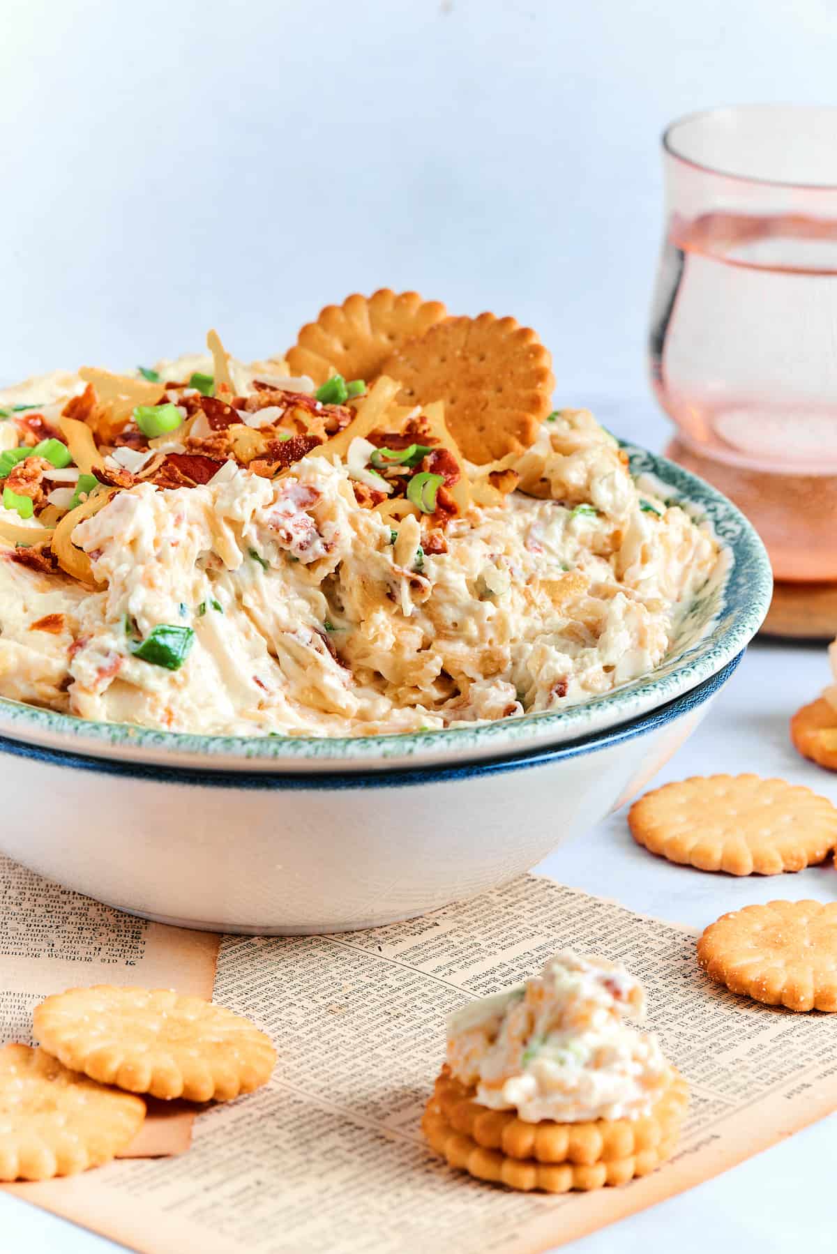 Neiman marcus cheese dip in a white and blue bowl with Ritz crackers