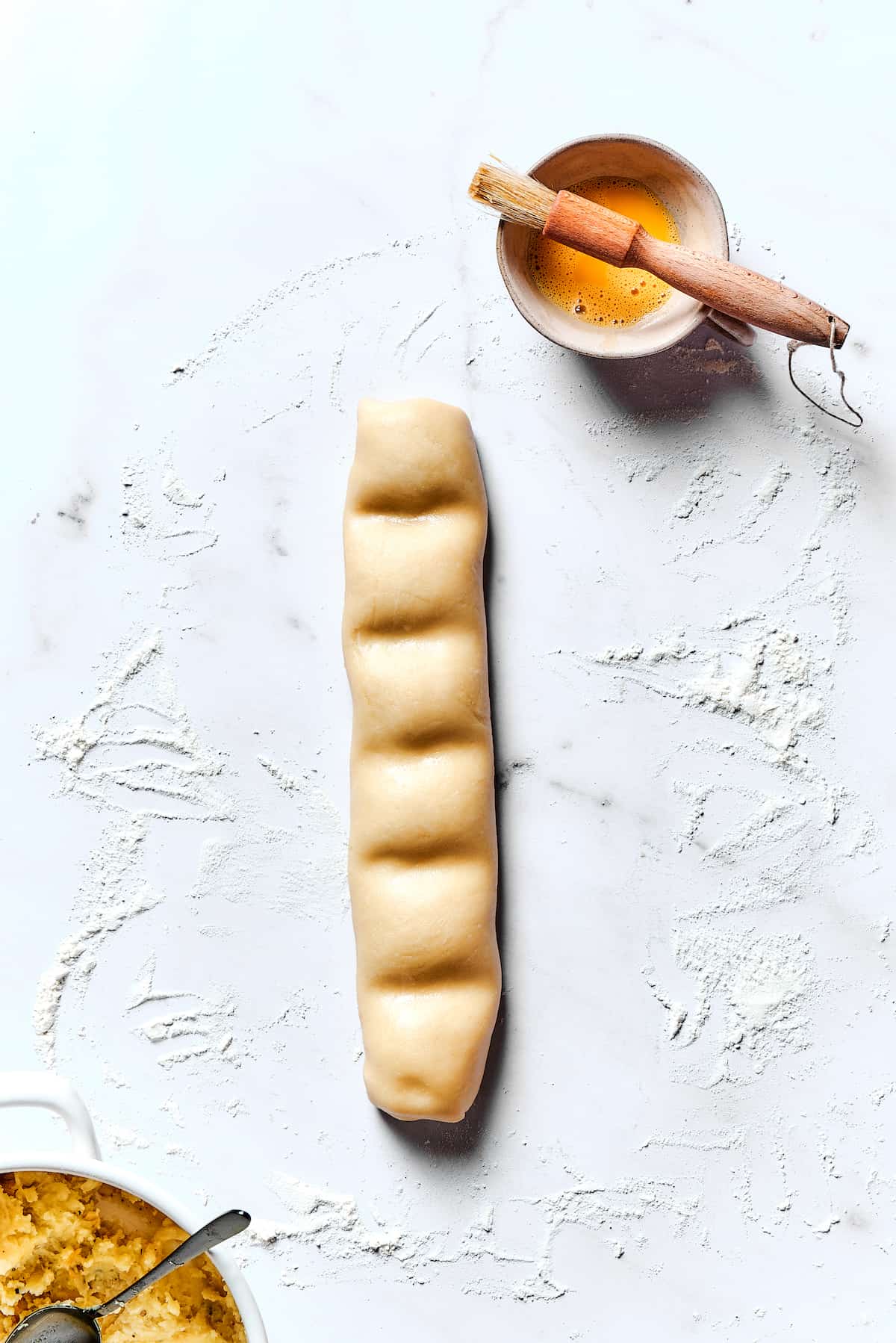 A roll of dough that's been sectioned into rectangles