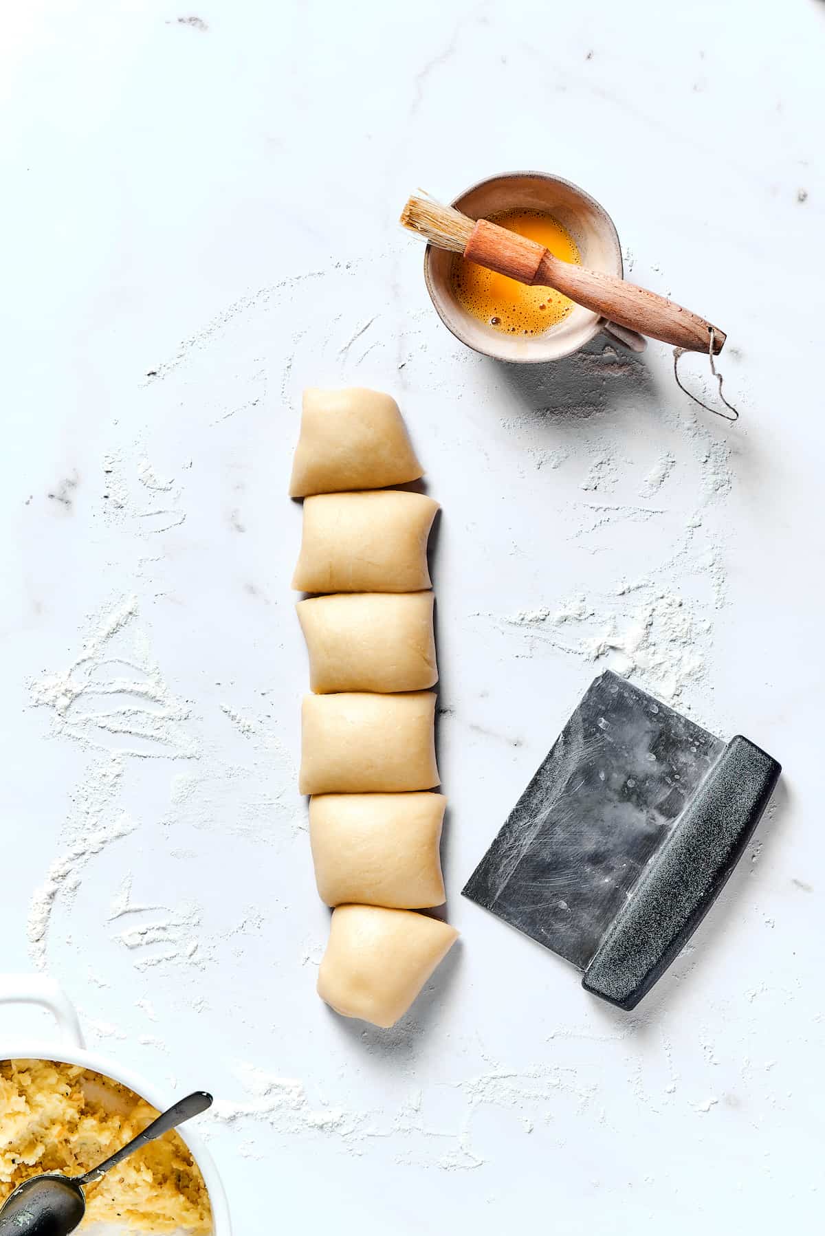 Dough stuffed with mashed potatoes that's been cut into squares