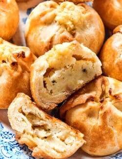 Close up of potato knishes, with one cut in half