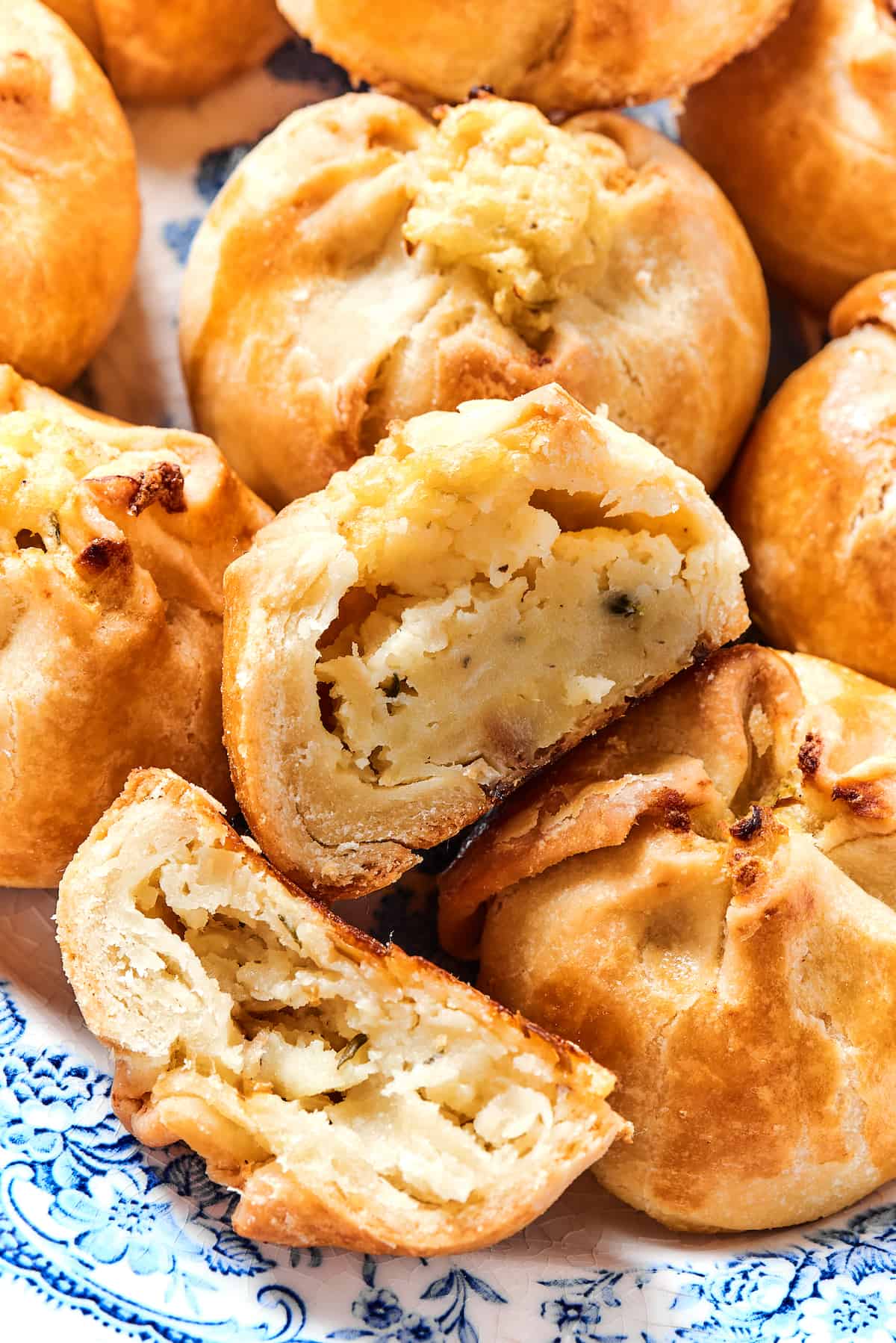 Close up of potato knishes, with one cut in half