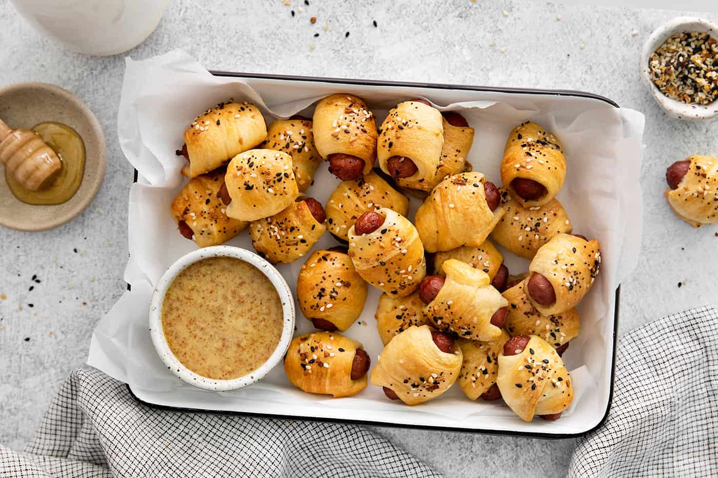 Overhead view of everything bagel pigs in a blanket on a tray