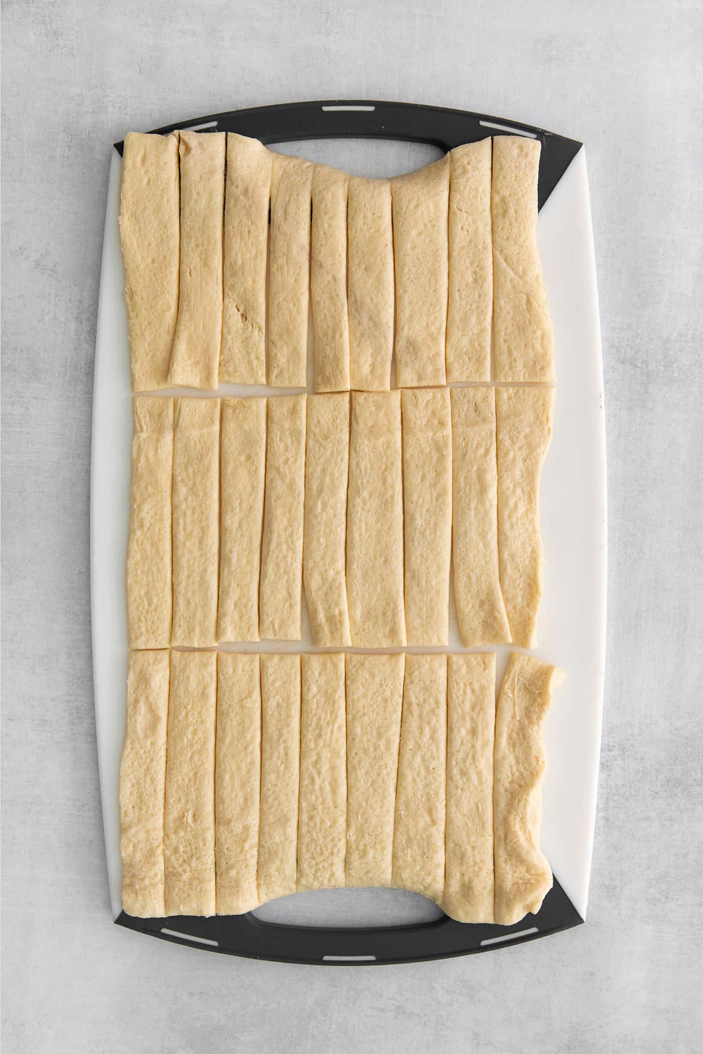 A sheet of crescent dough cut into strips