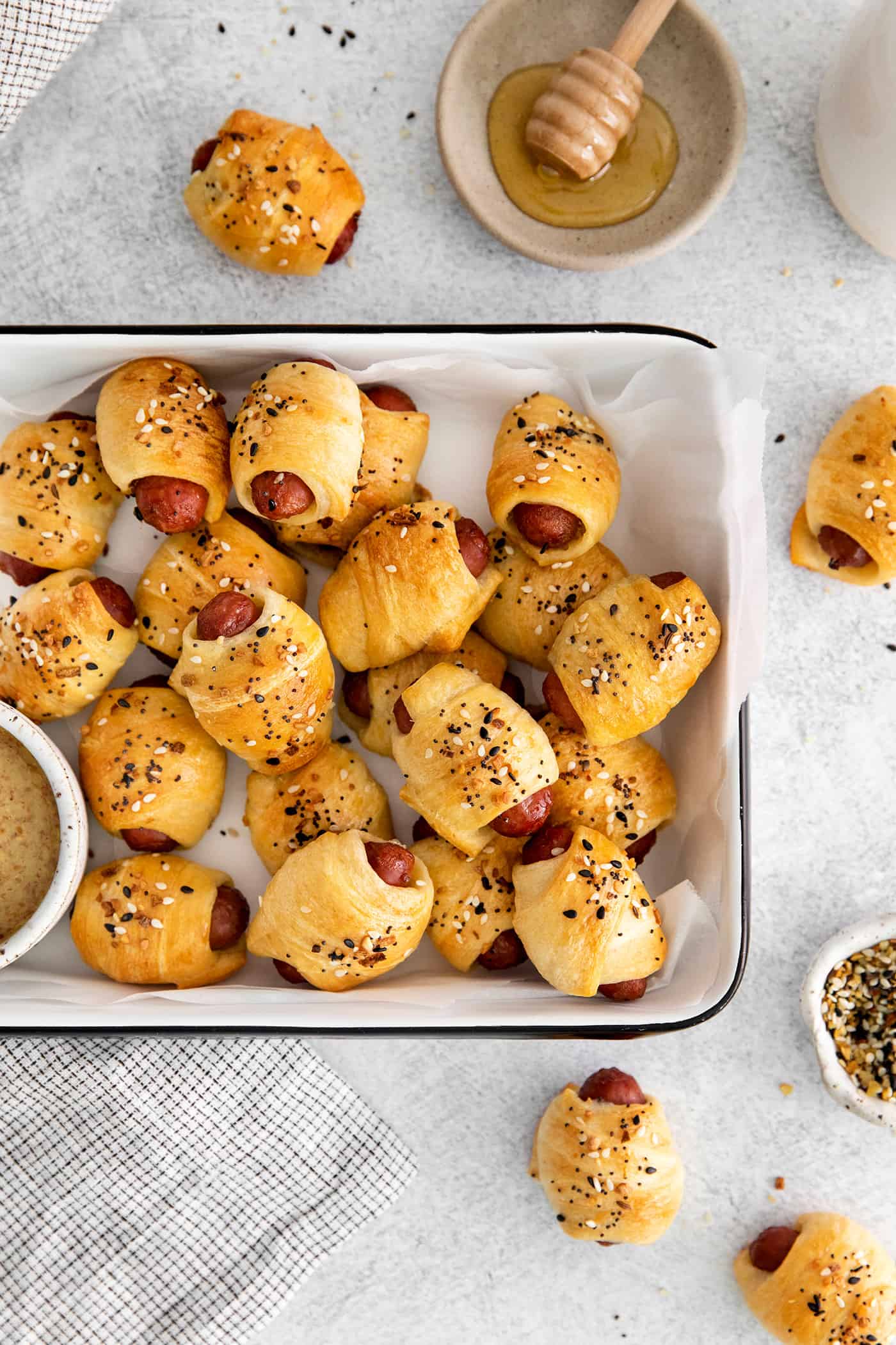 A serving tray of mini everything bagel pigs in a blanket