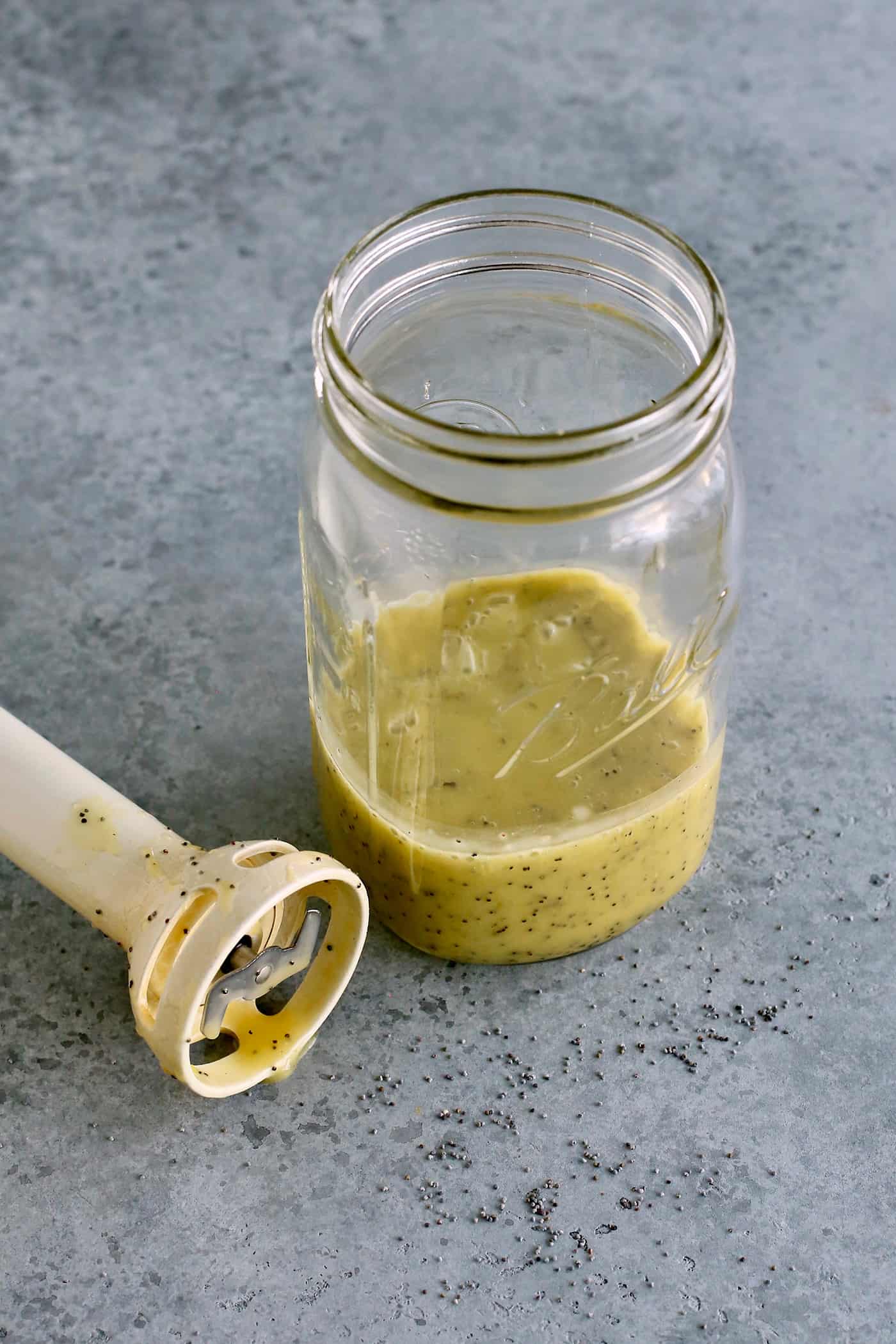 a jar of poppy seed dressing and an immersion blender