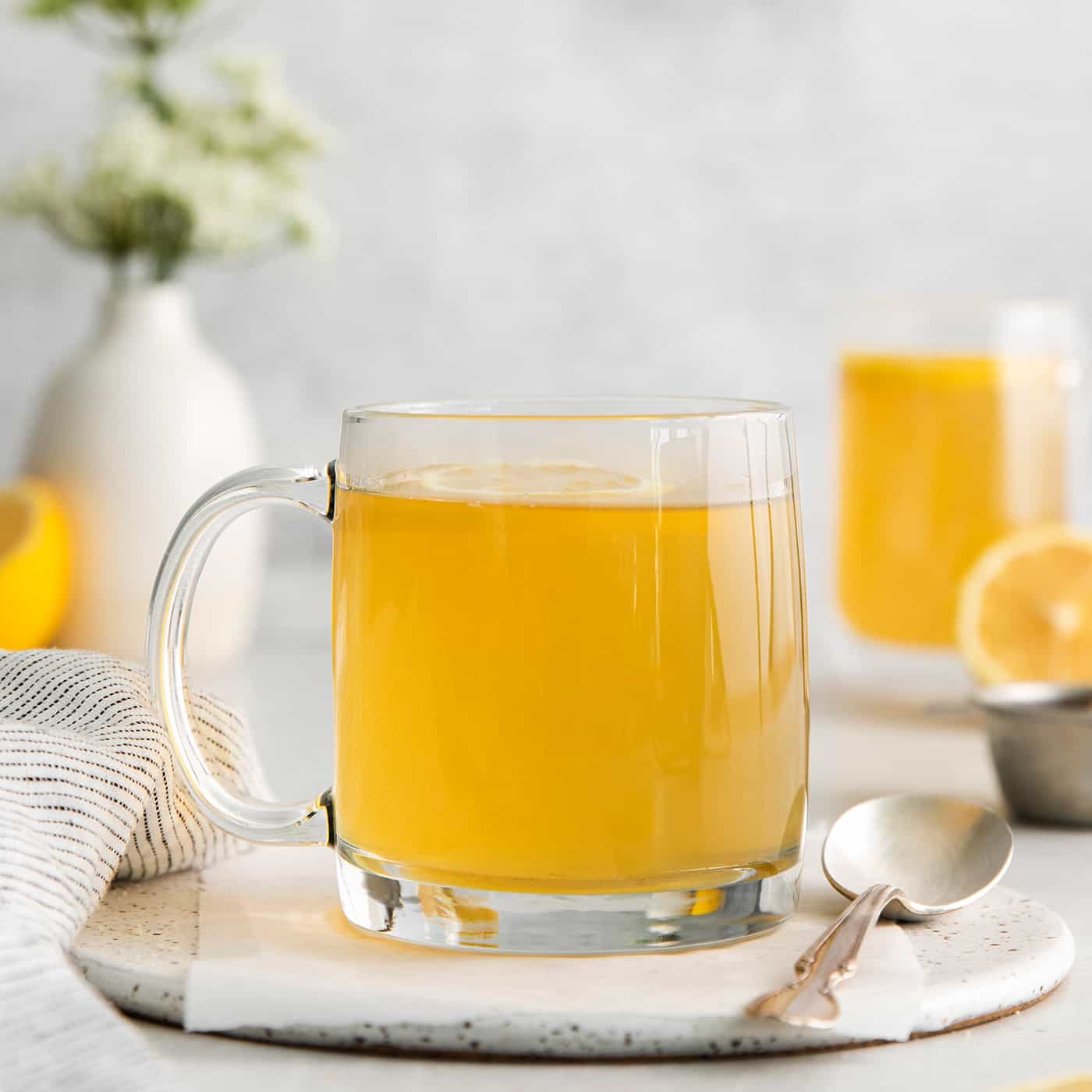 A clear mug of honey citrus mint tea