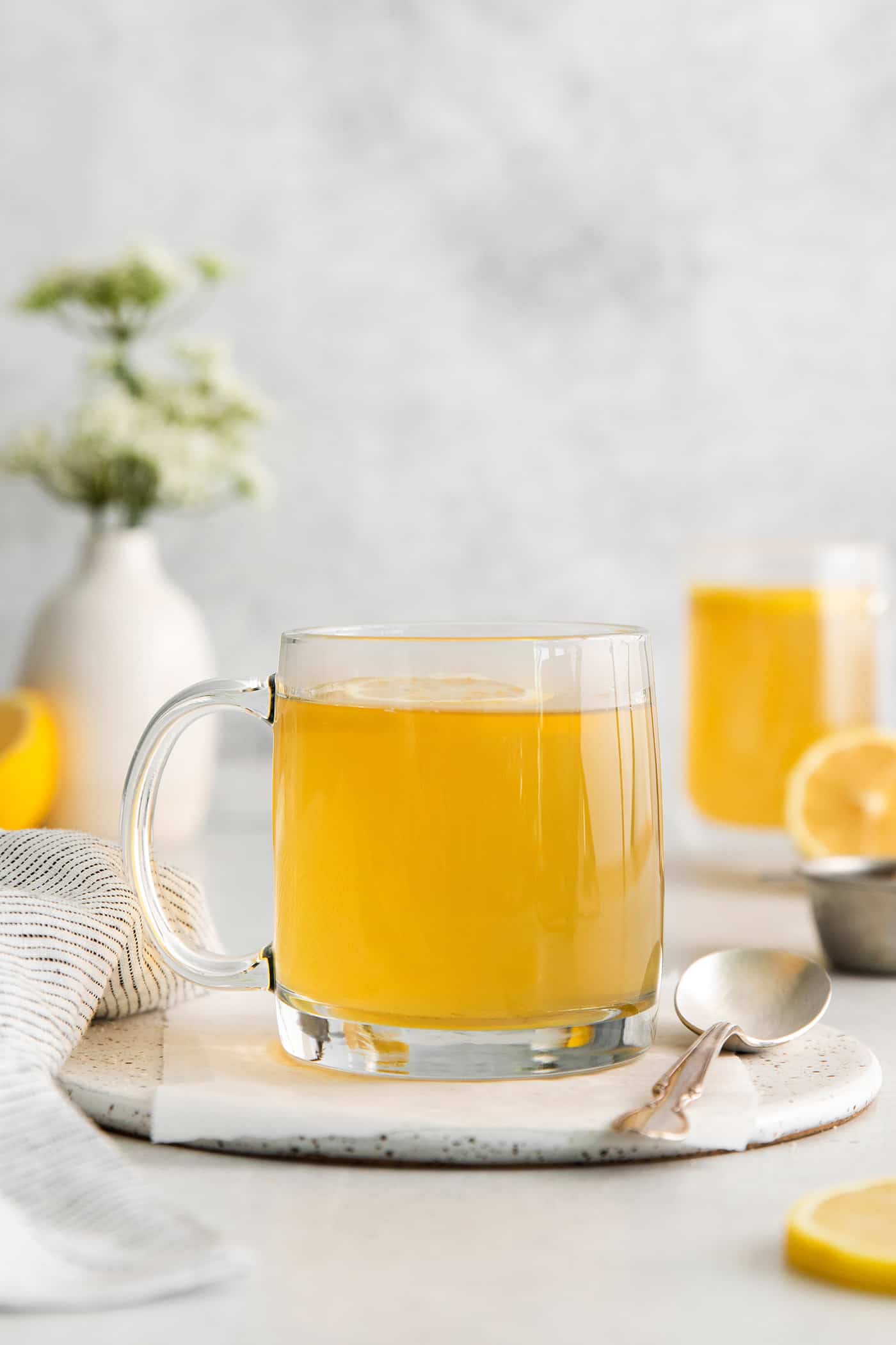 A clear mug of honey citrus mint tea