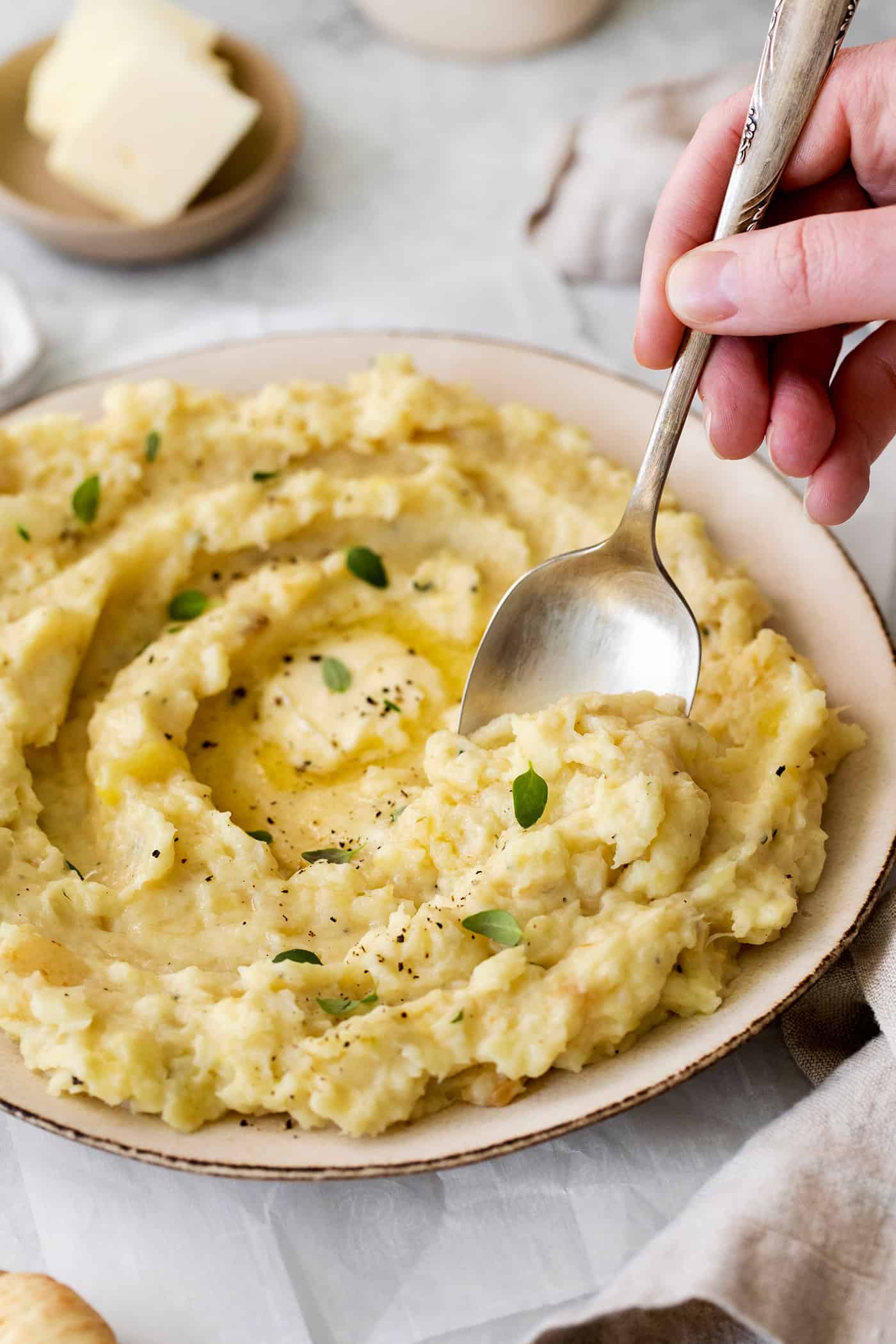 A spoon digging into a plate of parsnip puree