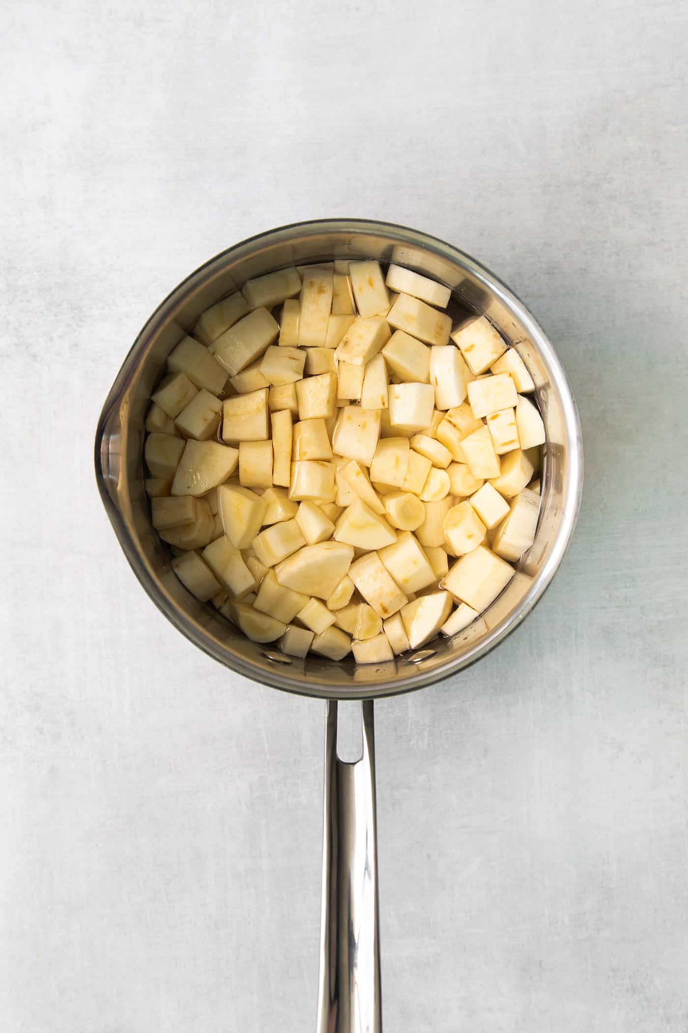 Chopped parsnip in a pot of water