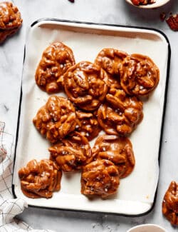 overhead view of pecan pralines on a white platter