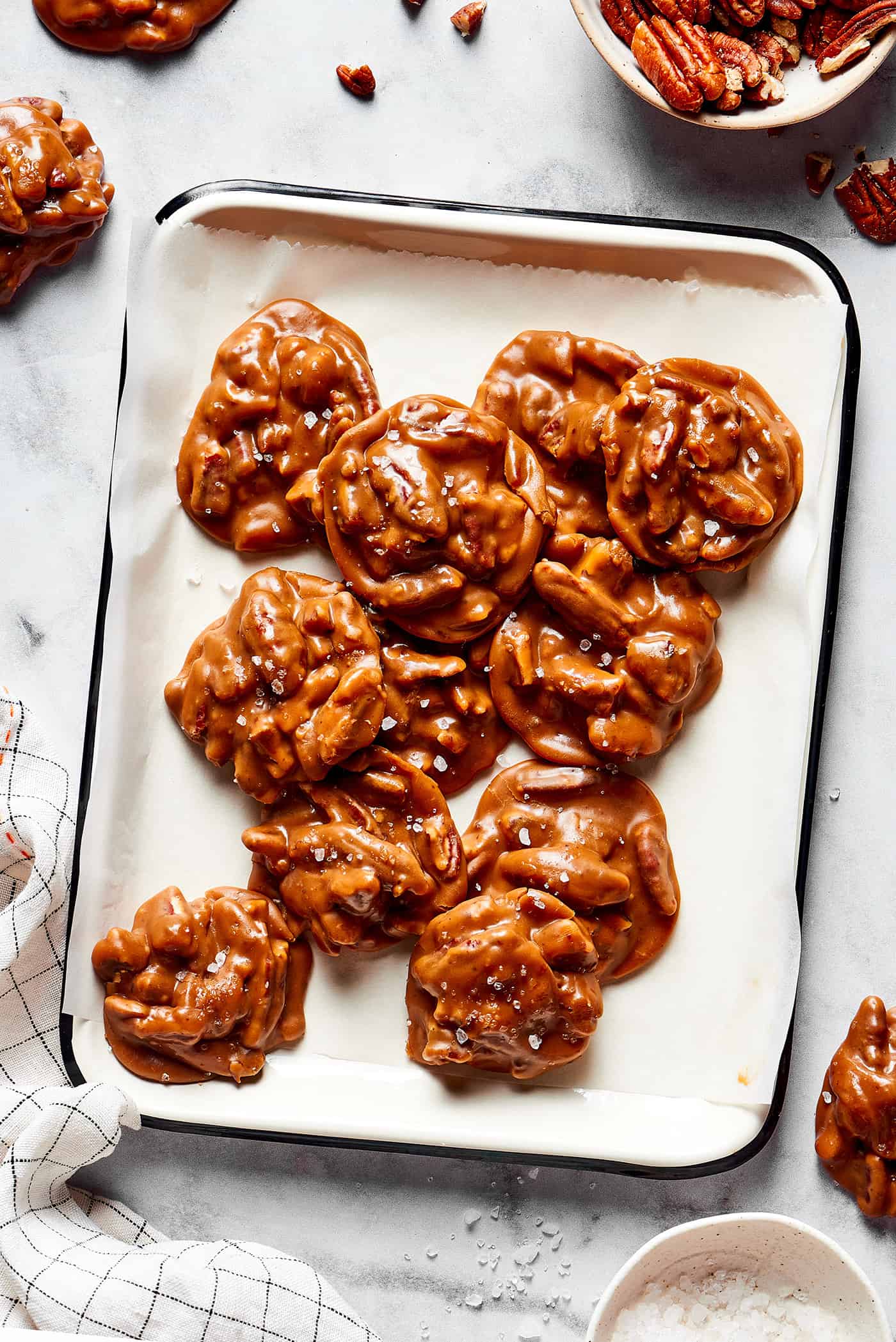 overhead view of pecan pralines on a white platter