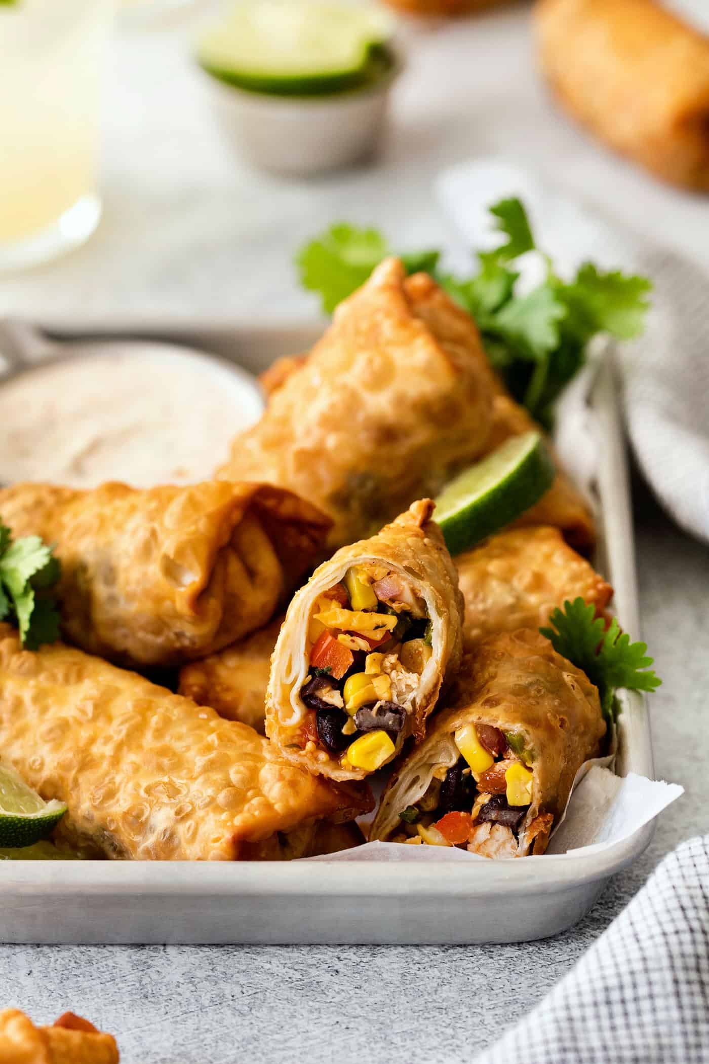 Southwest egg rolls on a tray, one cut open to show the inside