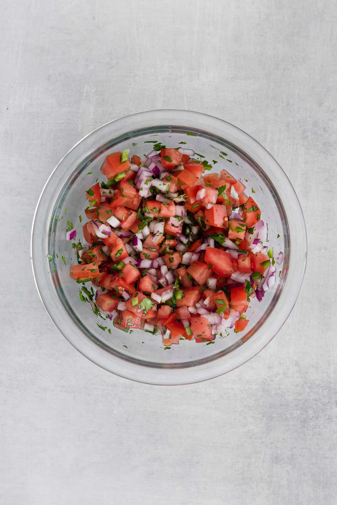 Homemade pico de gallo in a glass bowl