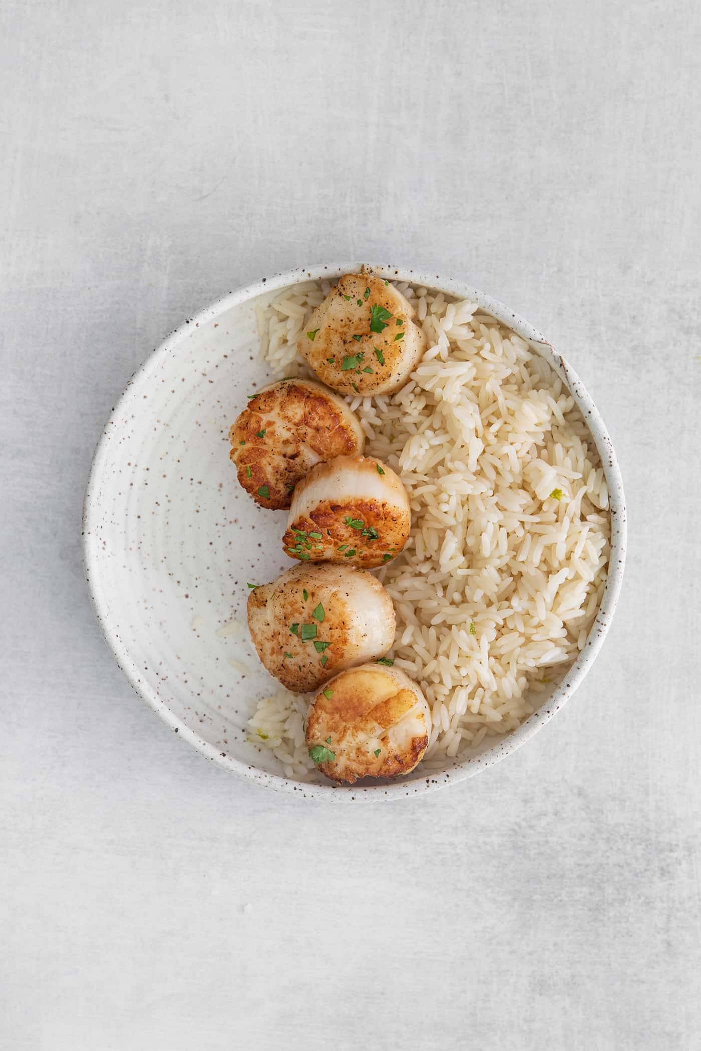 Seared scallops and rice in a bowl