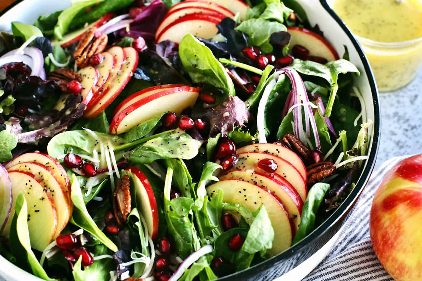 a large bowl of salad with apples