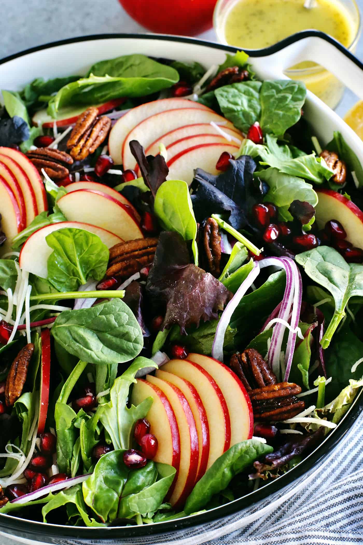 a big bowl of apple pecan salad with fresh greens