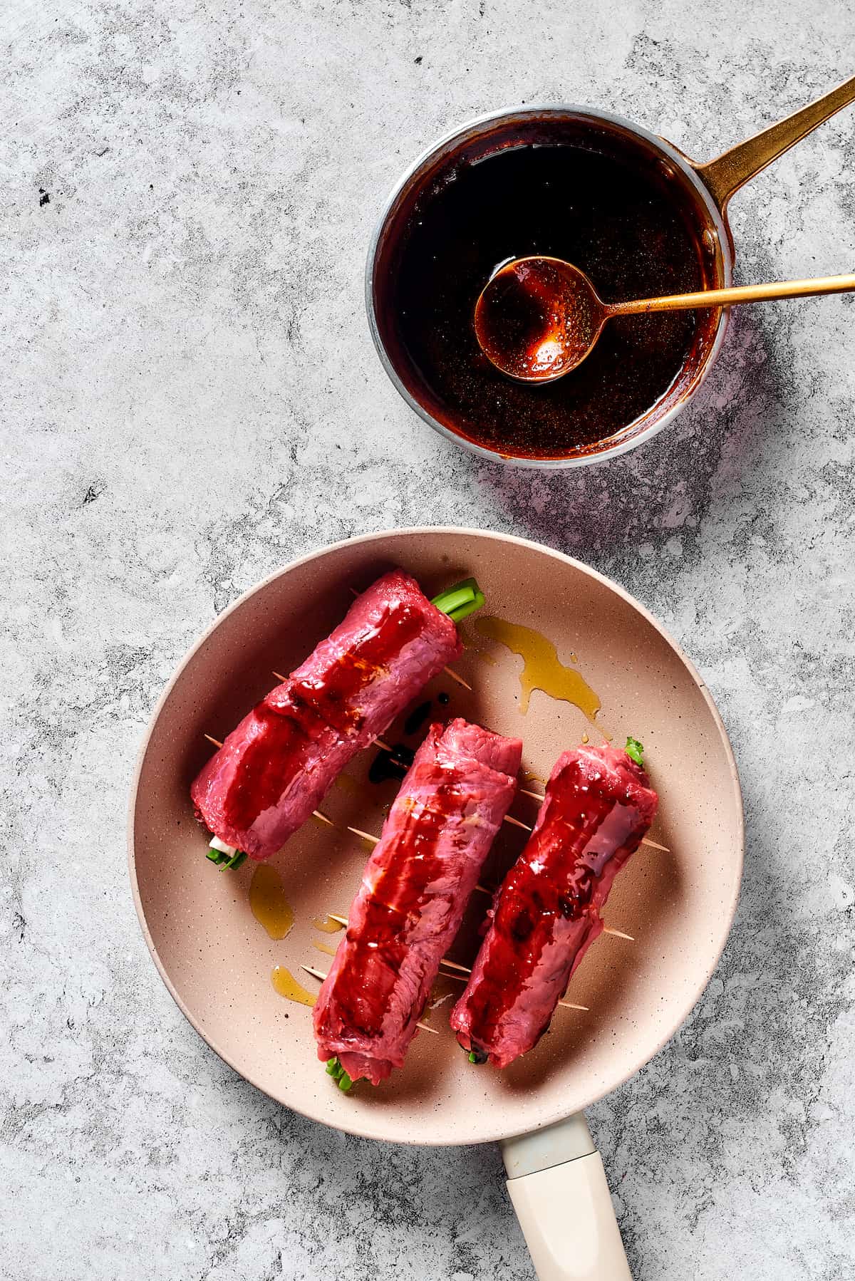 Beef and scallion rolls in a skillet