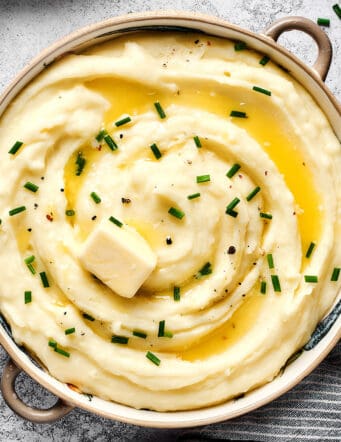 overhead photo of a big bowl of potatoes that are mashed with buttermilk