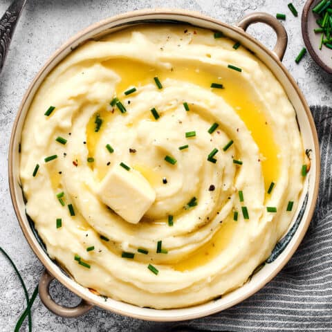 overhead photo of a big bowl of potatoes that are mashed with buttermilk