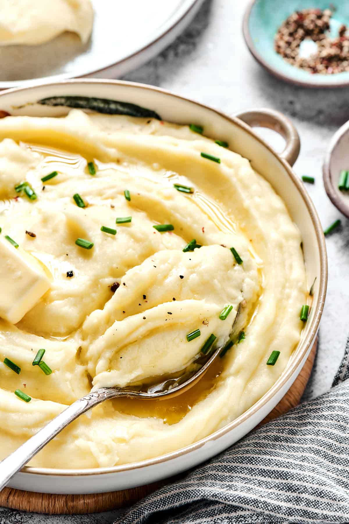 A spoon in a pan of mashed potatoes