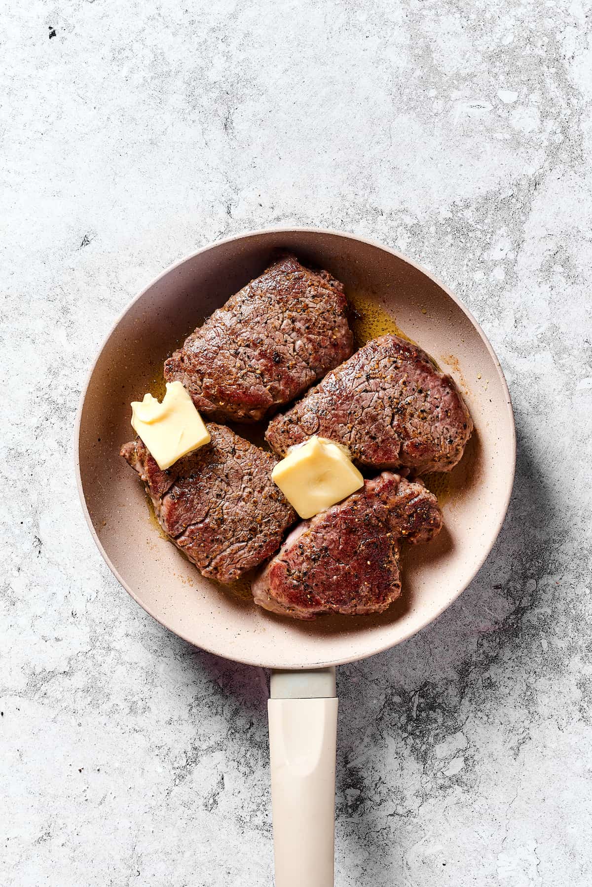 Seared beef tenderloin in a pan with butter