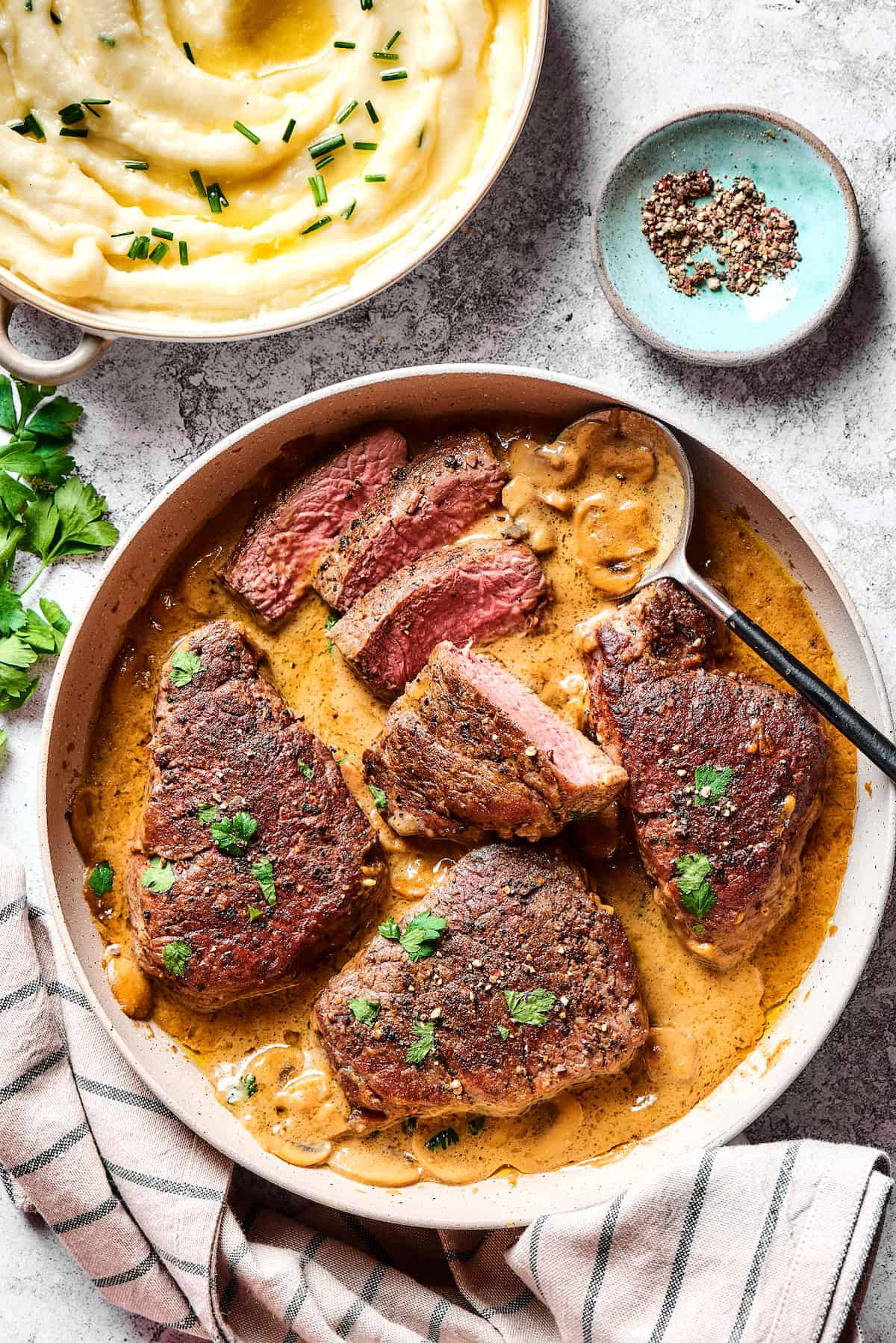 Overhead view of steak with Diane sauce in a pan