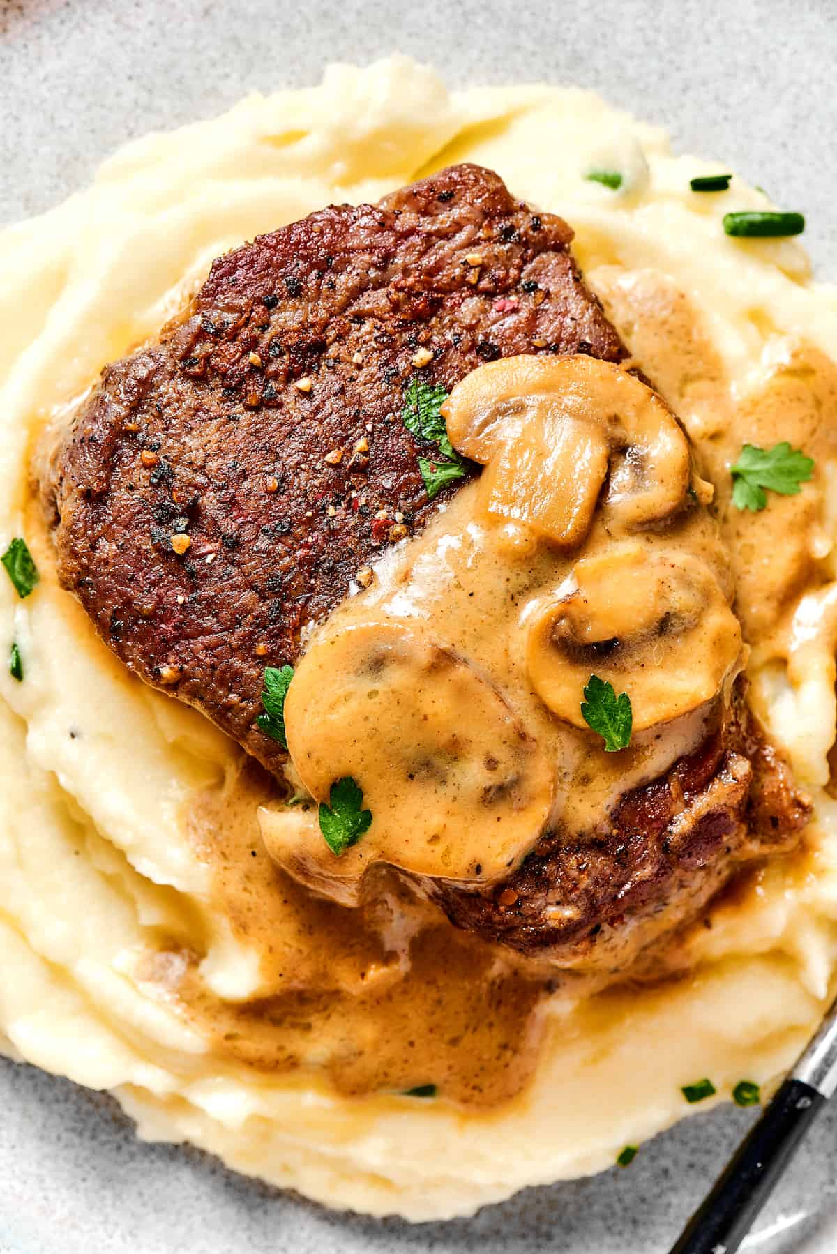 Overhead view of Steak diane over buttermilk mashed potatoes