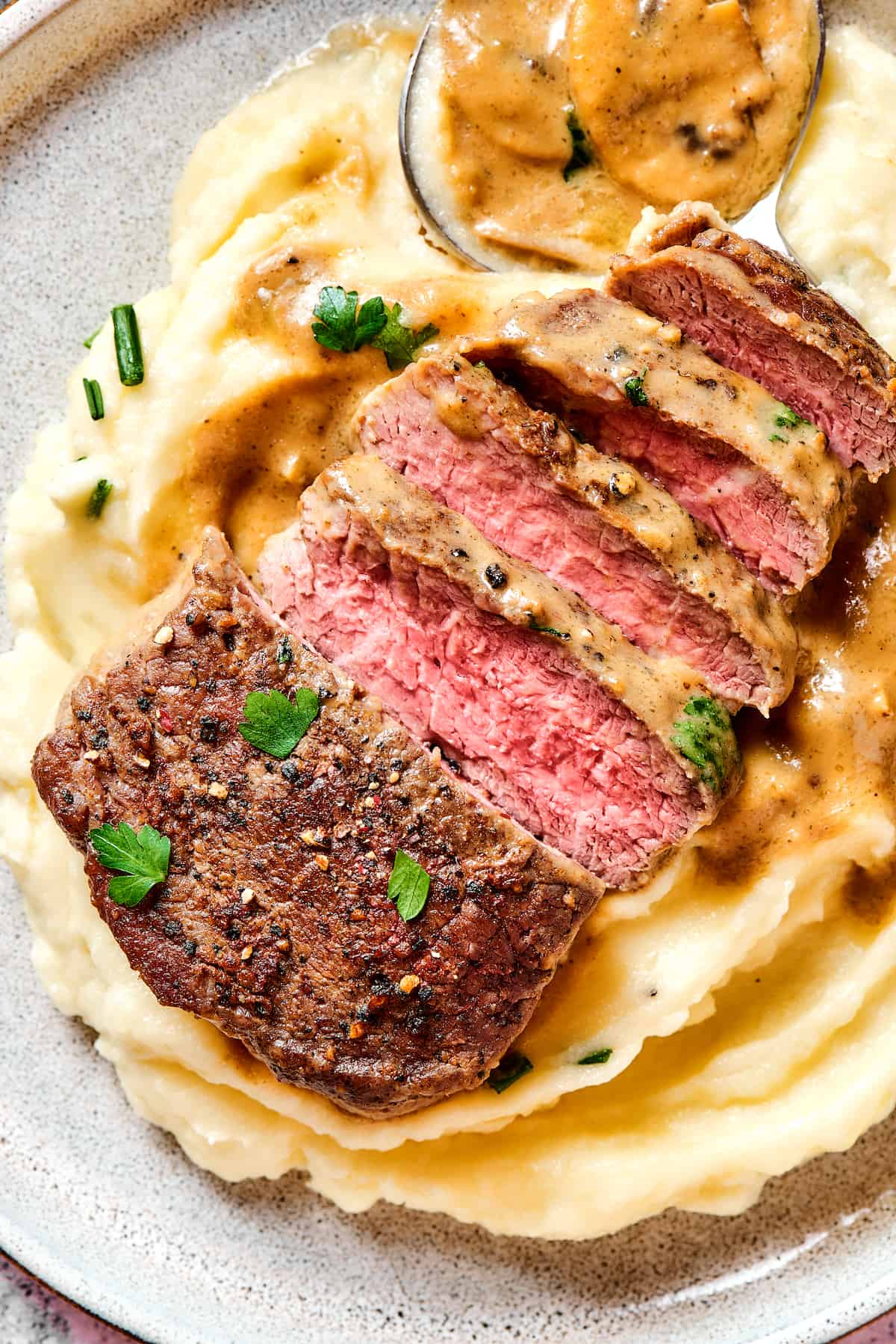 Sliced Steak Diane over mashed potatoes