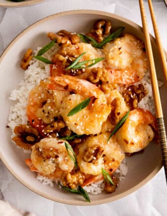 Overhead view of a plate of honey walnut shrimp over rice