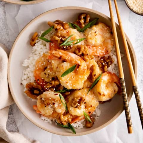 Overhead view of a plate of honey walnut shrimp over rice