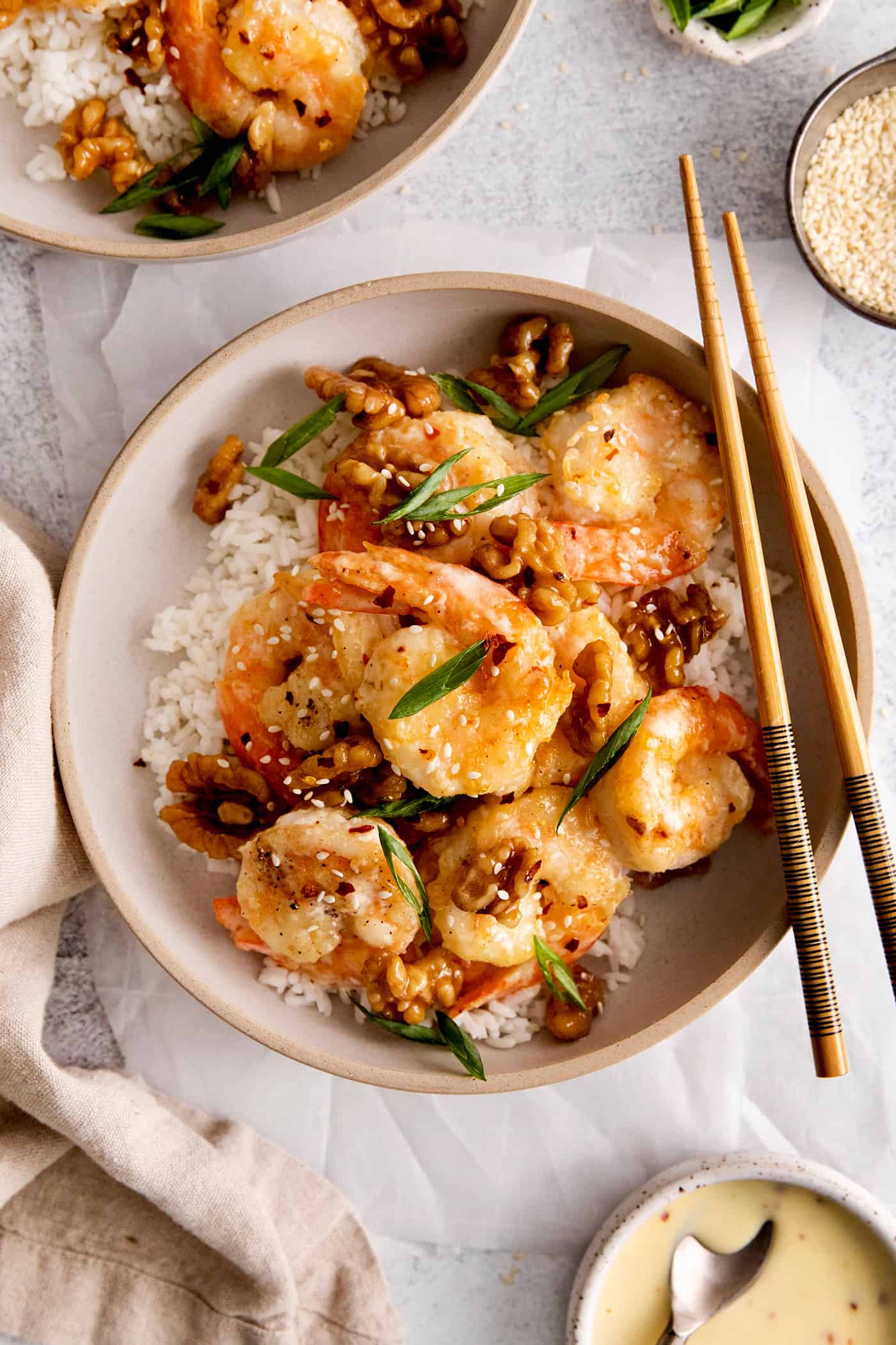 Honey walnut shrimp over rice on a white plate