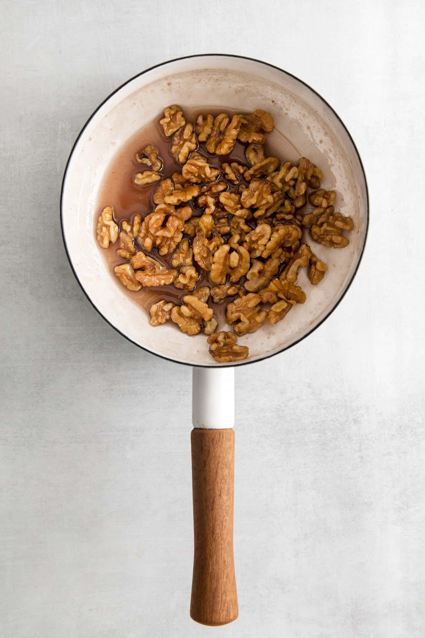 Walnuts in a pan with honey