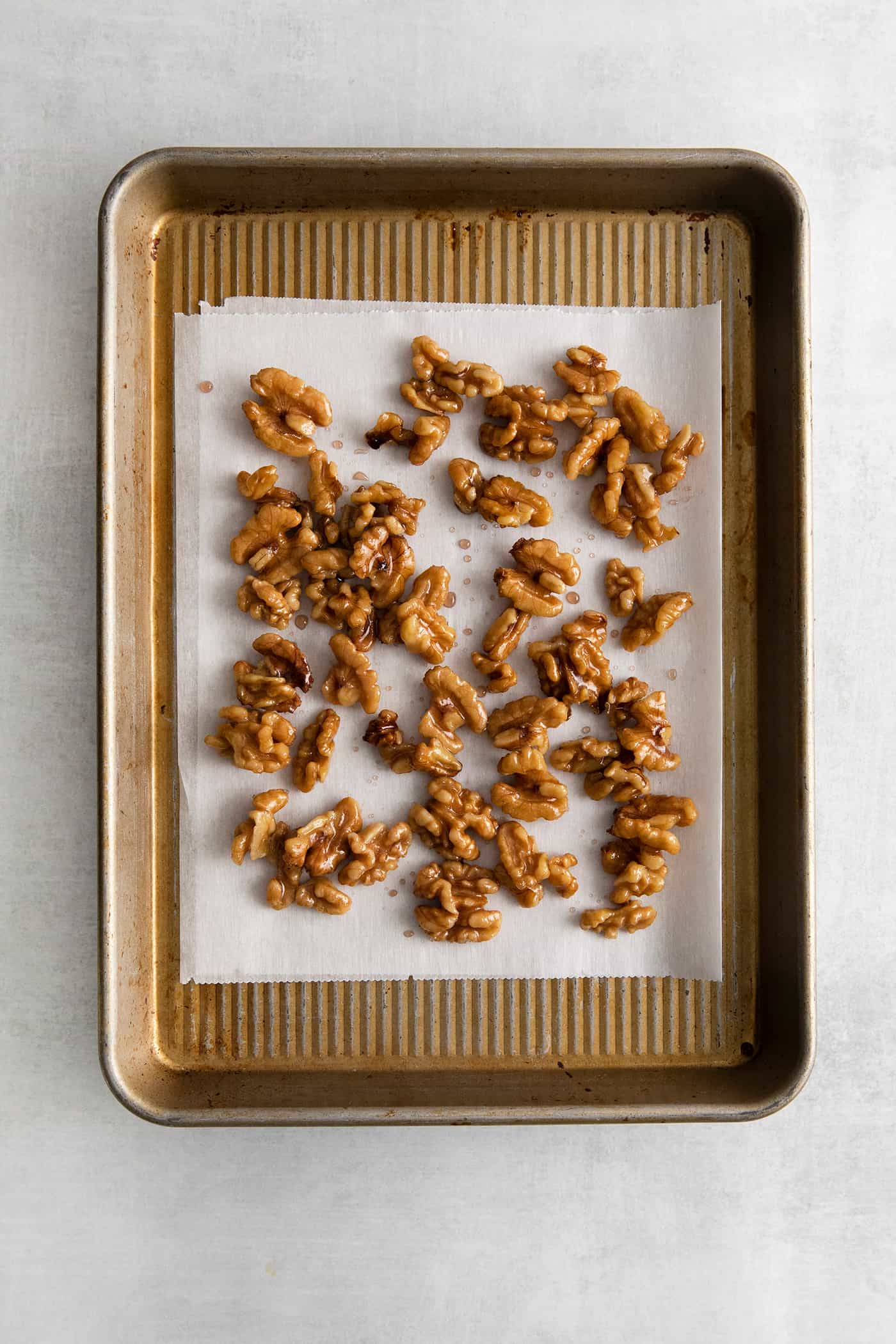 Honey walnuts on a baking sheet
