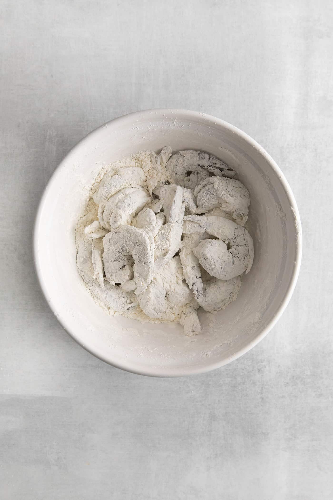 Shrimp coated with cornstarch in a bowl