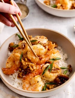 Chopsticks grabbing a piece of honey walnut shrimp