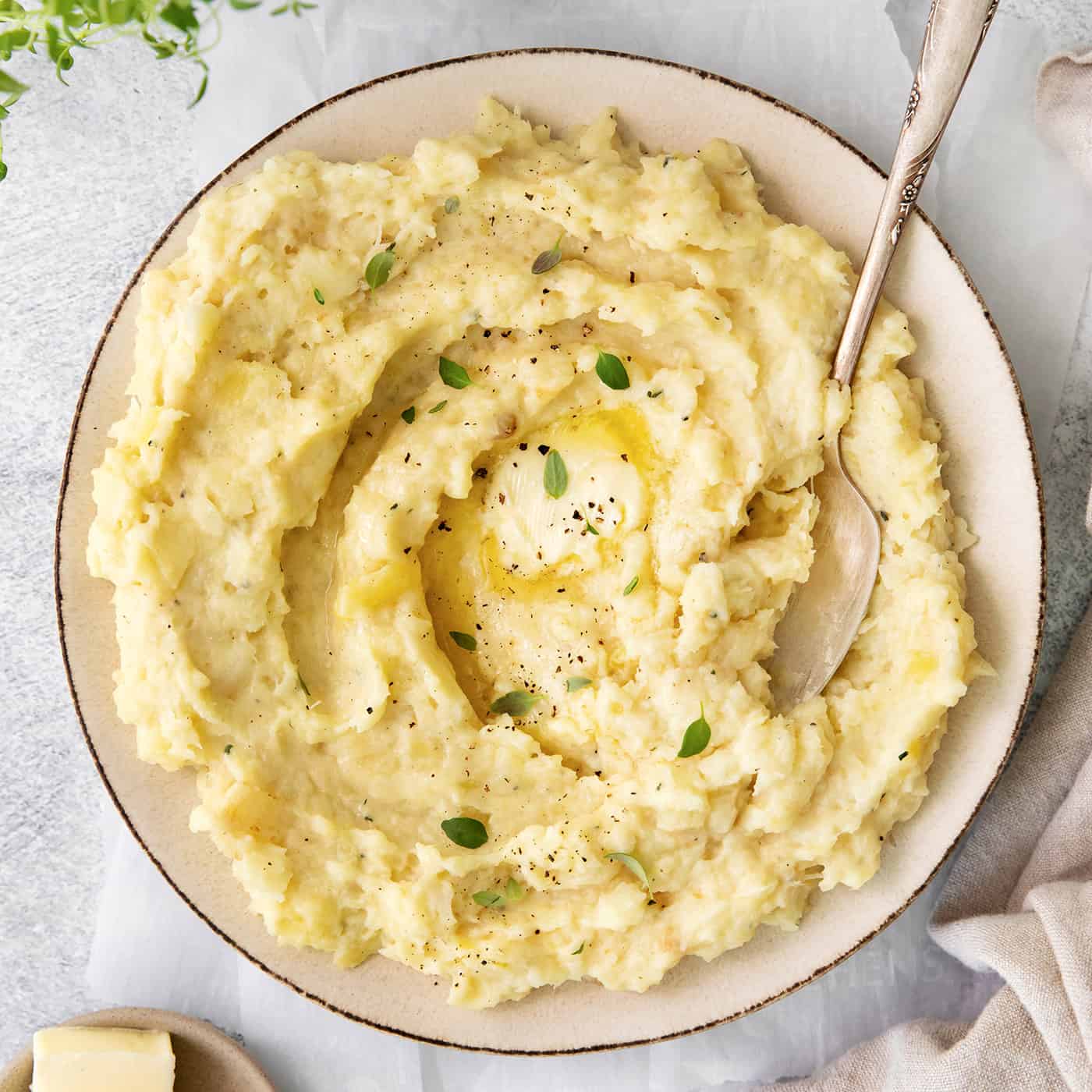 a bowl of parsnip puree with melted butter