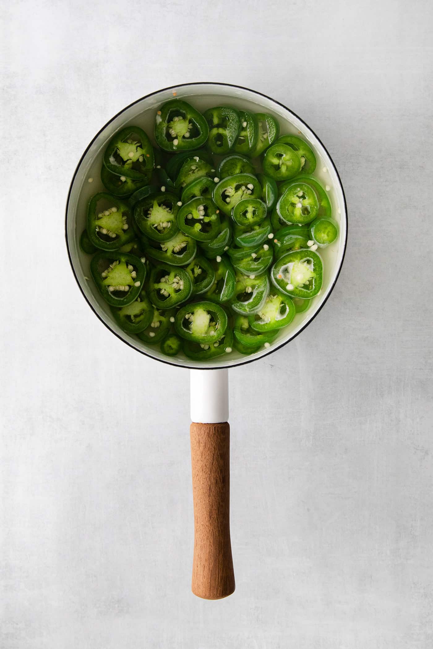 Overhead view of a saucepan of jalapenos