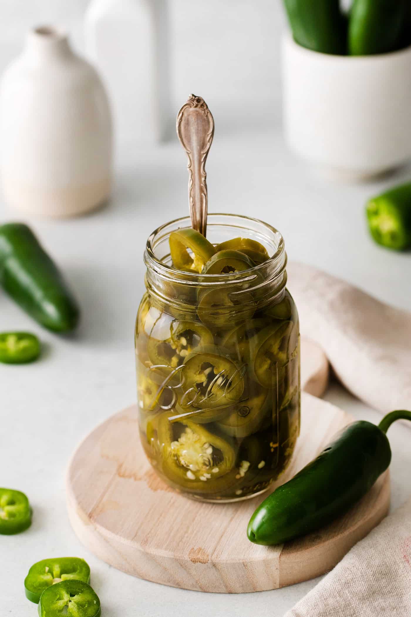 A jar of pickled jalapenos with a fork