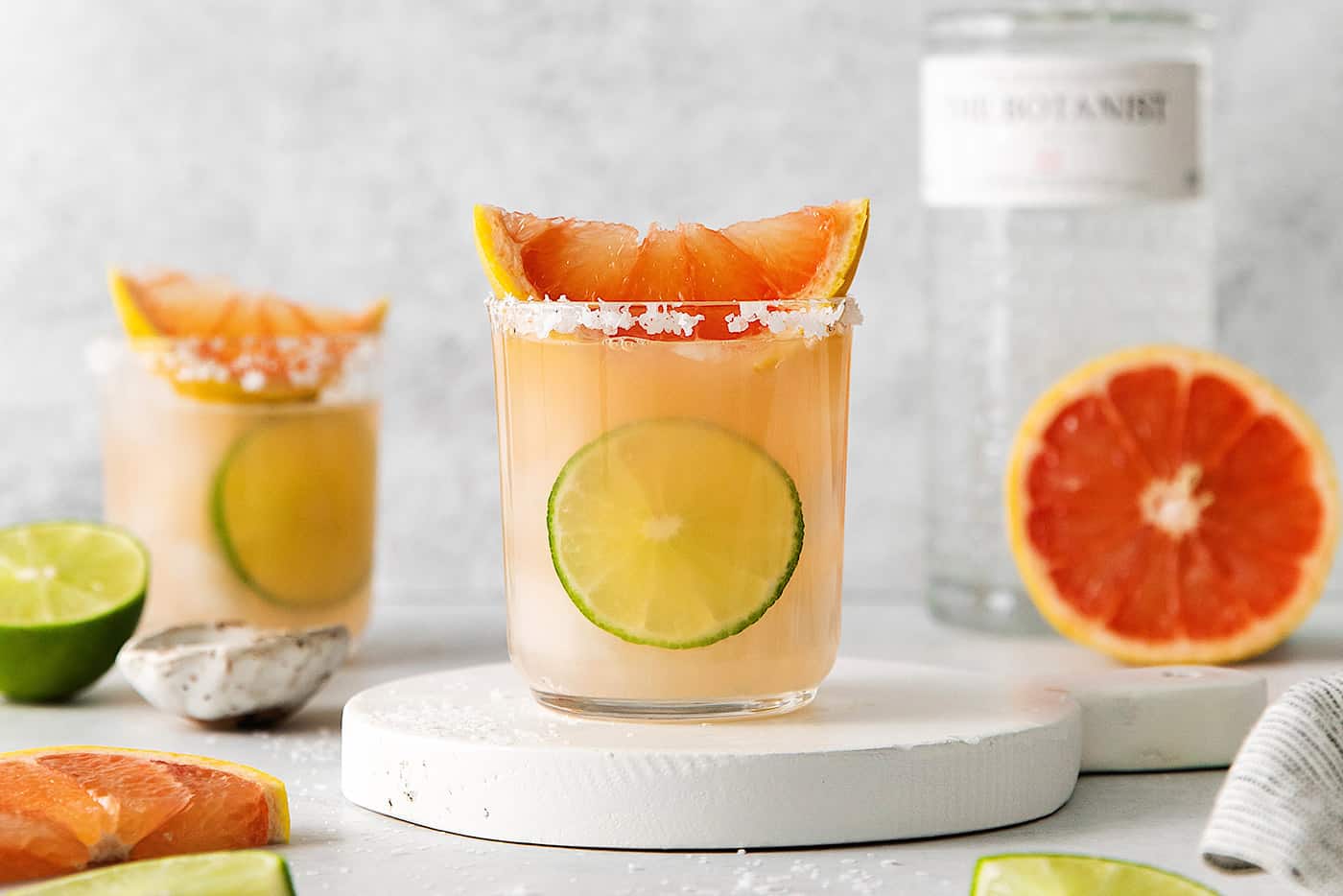 Two salty dog cocktails on white marble