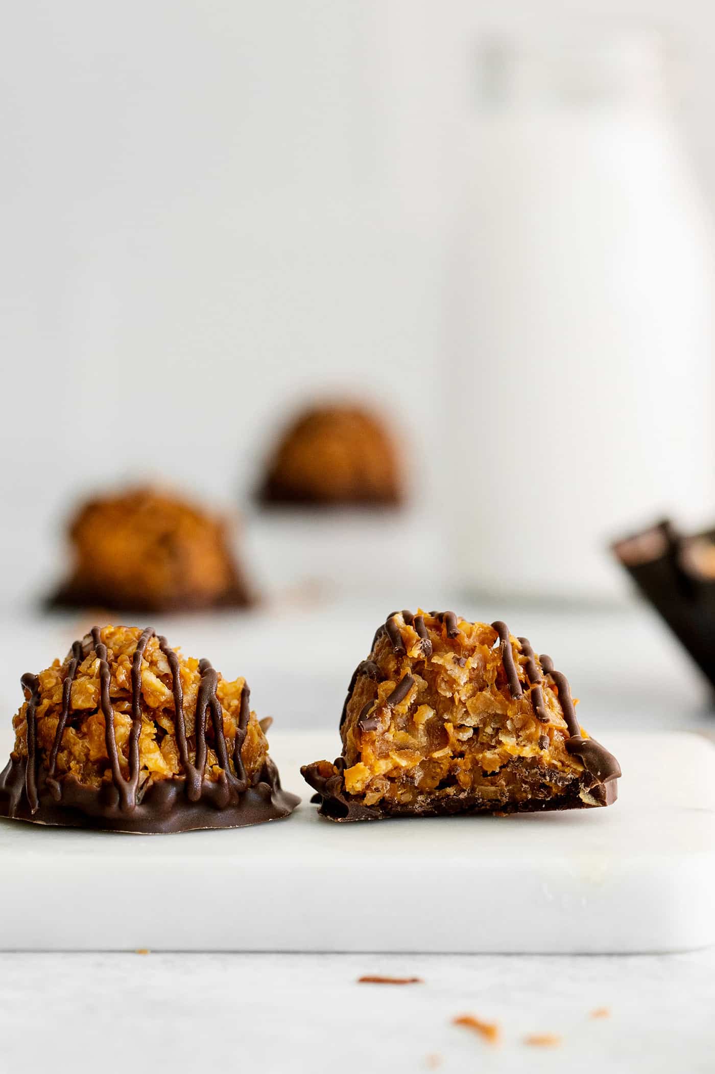 Two chocolate dipped dulce de leche macaroons