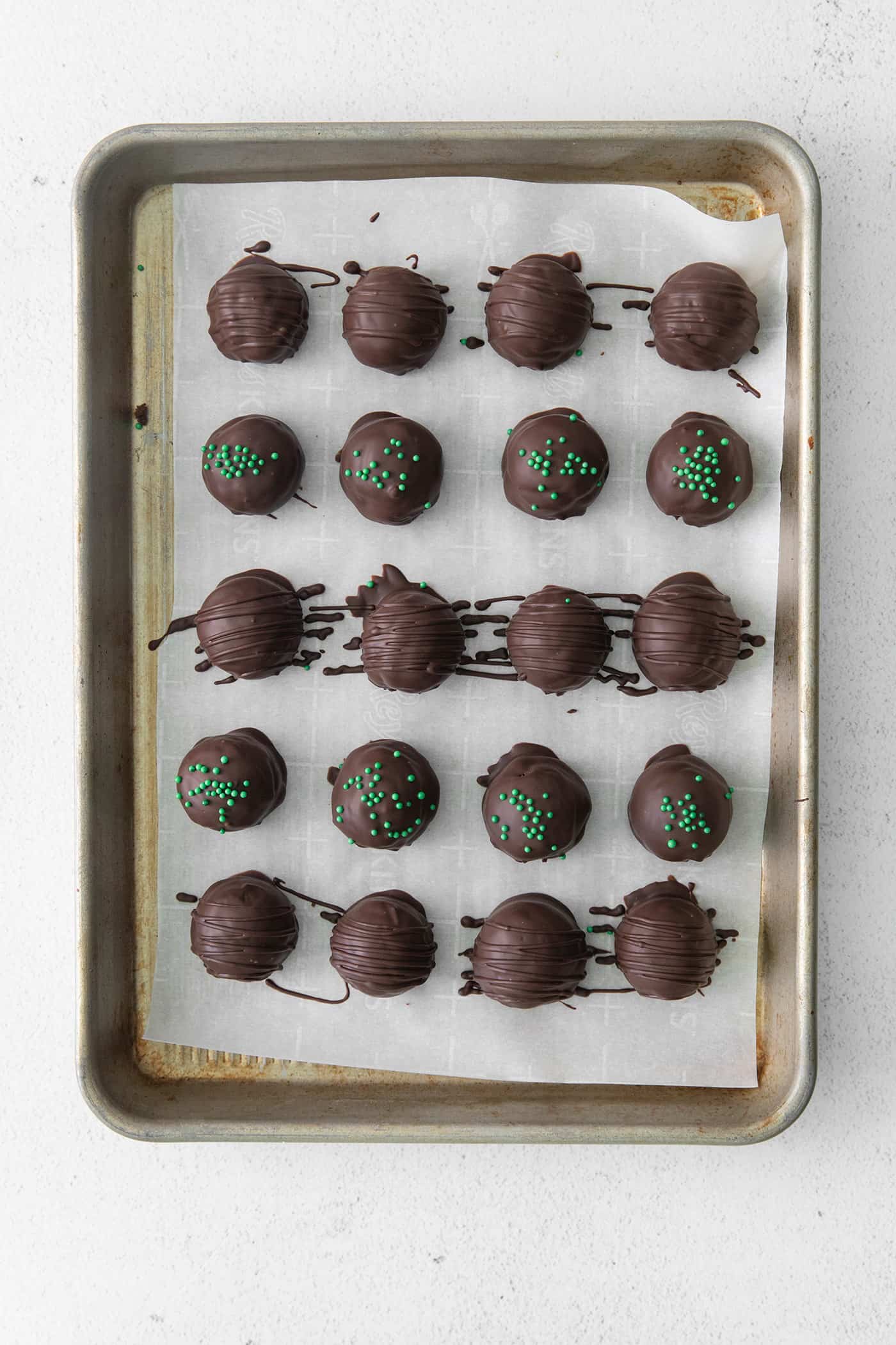 Overhead view of thin mint truffles on a baking sheet