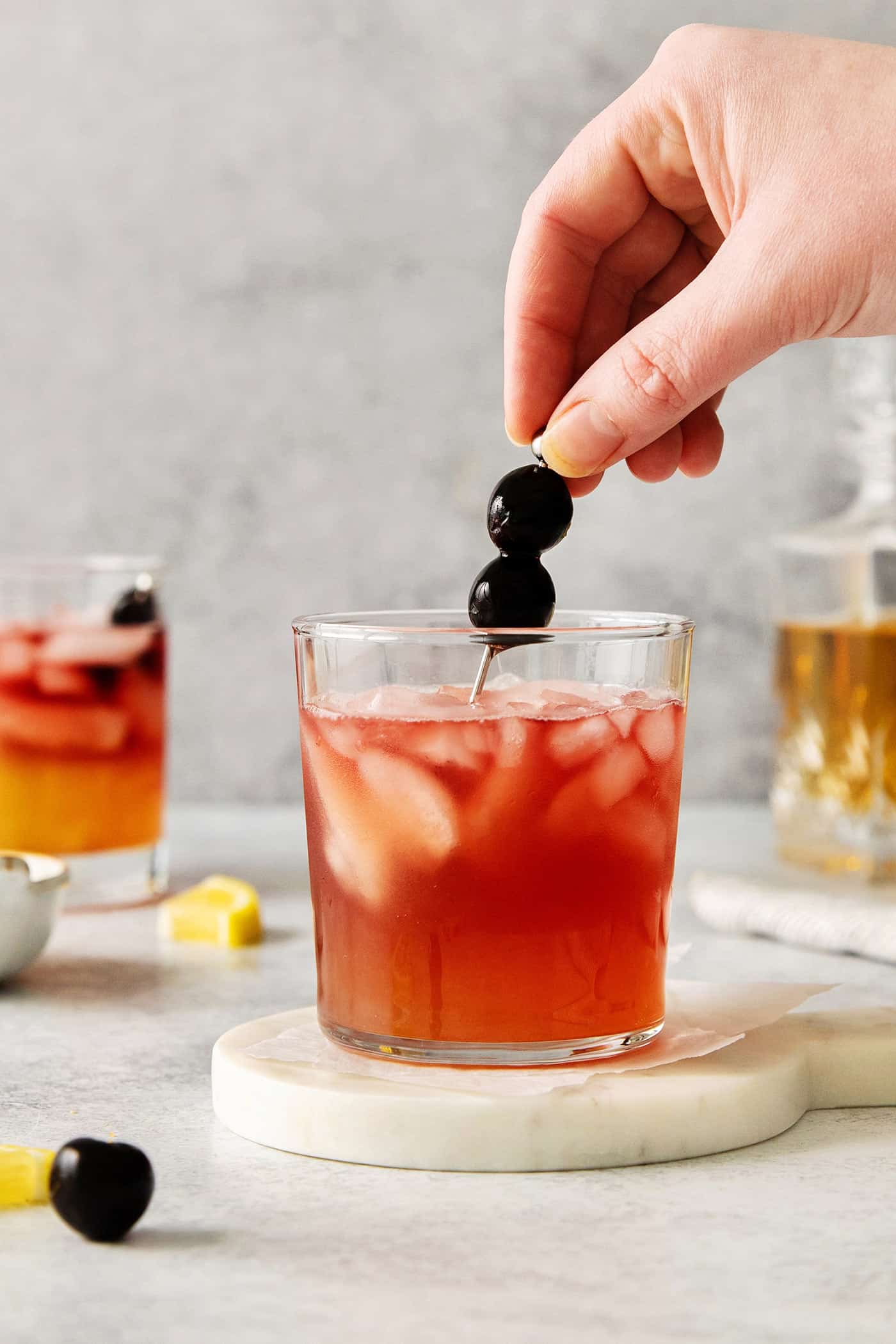 Stirring a New York Sour with a toothpick garnish