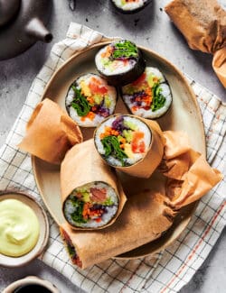 sushi burritos cut in half on a platter