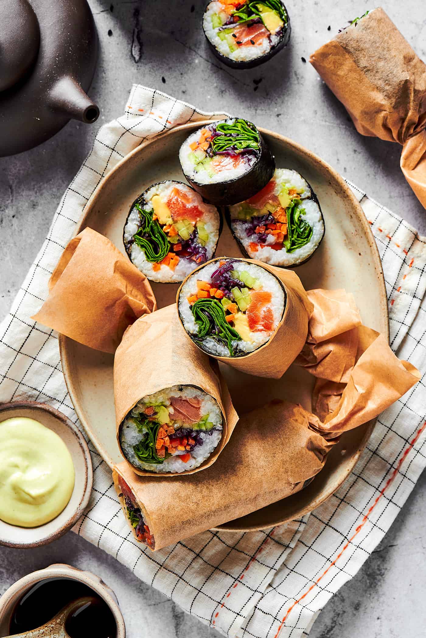 sushi burritos cut in half on a platter