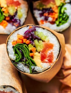 close-up photo of a cut burrito made of sushi ingredients